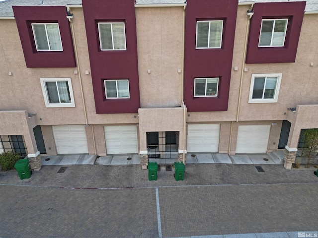 view of front of home featuring an attached garage and stucco siding