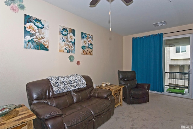 carpeted living area with ceiling fan and visible vents