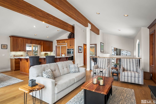 living room with light wood-style flooring, recessed lighting, lofted ceiling with beams, and baseboards