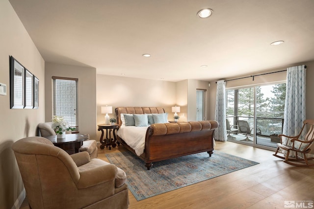 bedroom featuring access to outside, recessed lighting, and wood finished floors