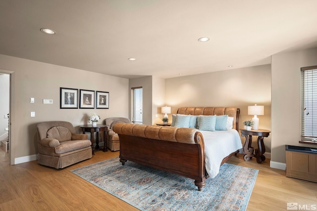 bedroom featuring light wood finished floors, baseboards, and recessed lighting