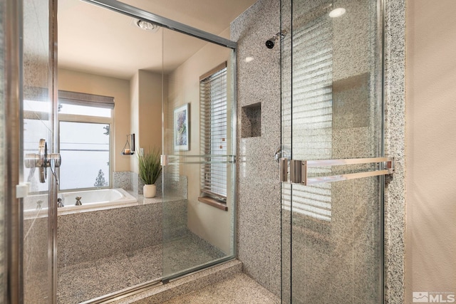 bathroom with a stall shower and a bath