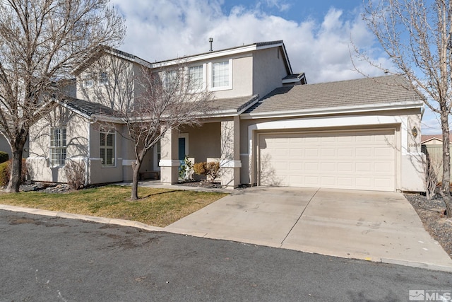 traditional-style home featuring a front lawn, an attached garage, driveway, and stucco siding