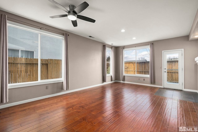 spare room featuring visible vents, baseboards, recessed lighting, hardwood / wood-style flooring, and a ceiling fan