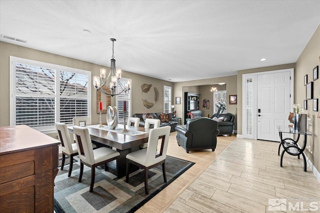 dining room with recessed lighting, a notable chandelier, visible vents, baseboards, and light wood-style floors