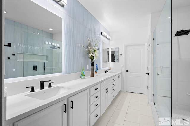 bathroom featuring double vanity, a sink, and walk in shower