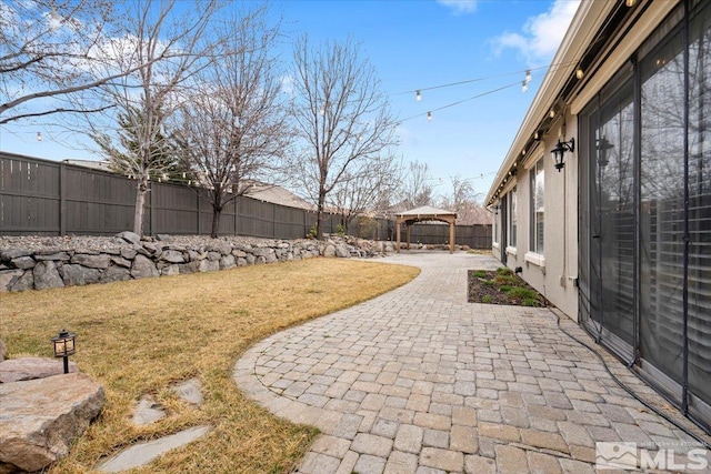 view of yard with a fenced backyard, a patio, and a gazebo