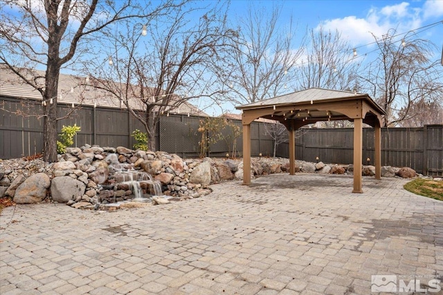 view of patio featuring a fenced backyard and a gazebo