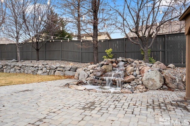 view of yard featuring fence and a patio