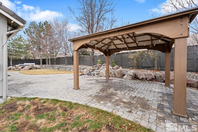 view of patio with a fenced backyard and a gazebo