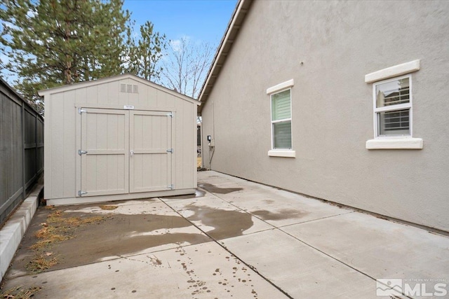 view of shed with fence