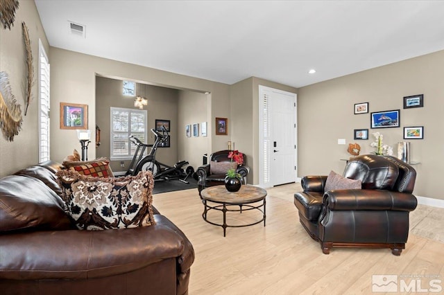 living area featuring baseboards, recessed lighting, visible vents, and light wood-style floors