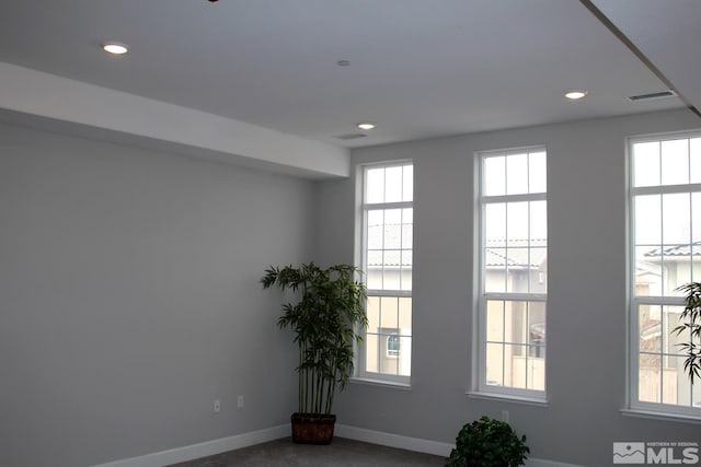 spare room with a wealth of natural light, visible vents, baseboards, and recessed lighting