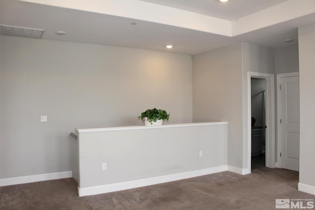 spare room featuring carpet floors, baseboards, visible vents, and recessed lighting