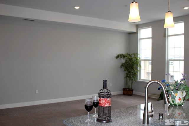 kitchen with carpet, plenty of natural light, and baseboards