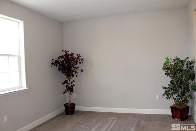 empty room with carpet and baseboards