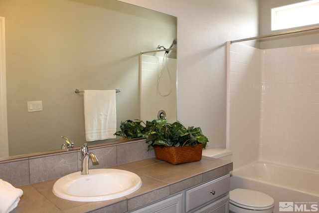 full bath featuring toilet, shower / bathing tub combination, and vanity