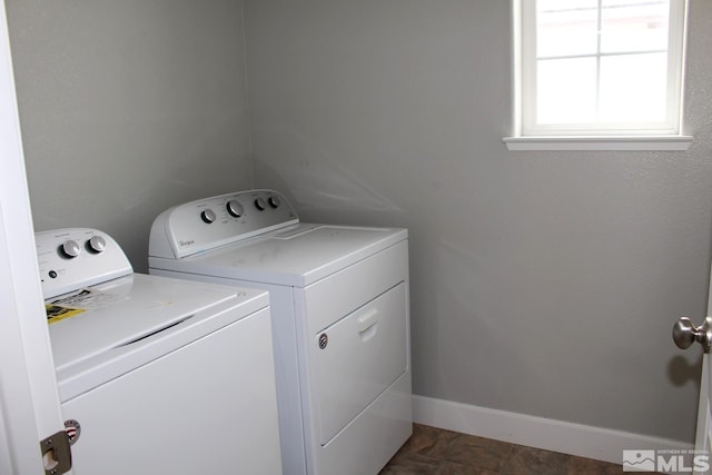 laundry room with laundry area, baseboards, and separate washer and dryer