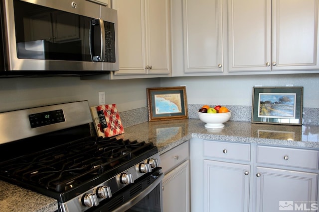 kitchen featuring appliances with stainless steel finishes and white cabinetry