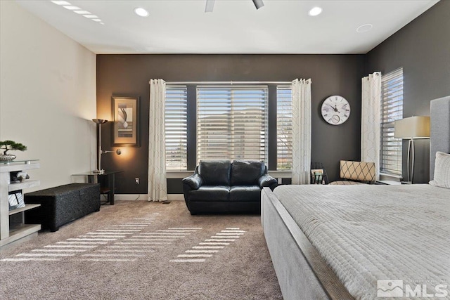 carpeted bedroom with multiple windows, recessed lighting, and baseboards