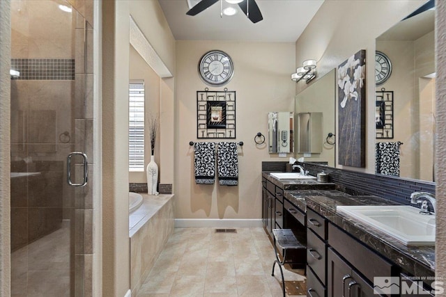 bathroom featuring a garden tub, a sink, tile patterned floors, double vanity, and a stall shower