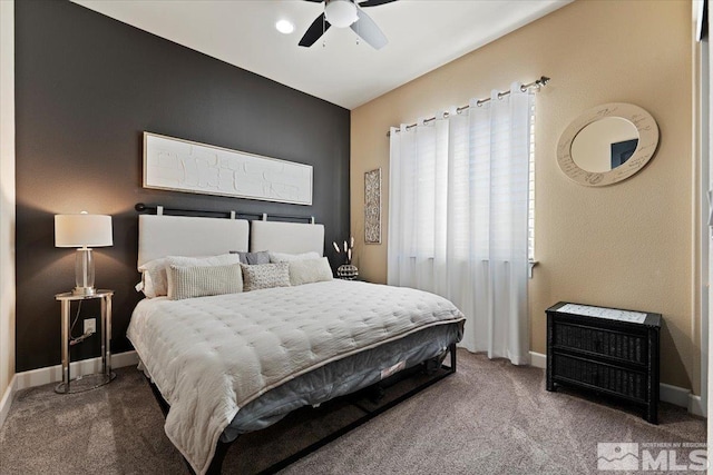 carpeted bedroom with baseboards and a ceiling fan