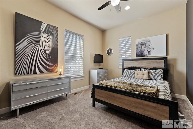 bedroom featuring ceiling fan, multiple windows, carpet, and baseboards