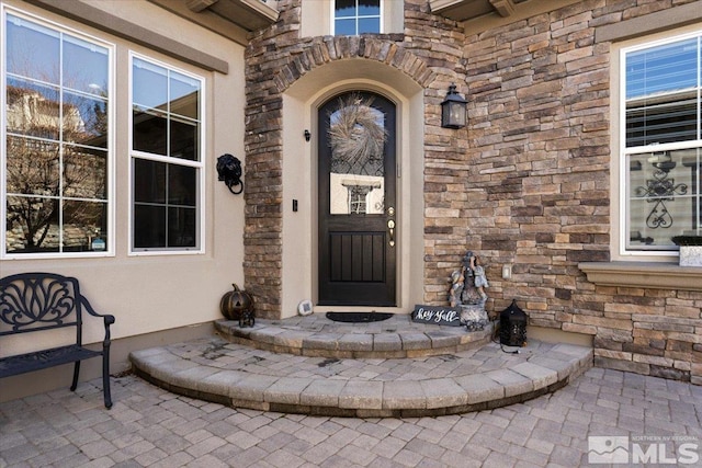 entrance to property with stone siding