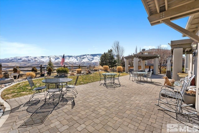 view of patio featuring outdoor dining area and a mountain view