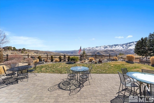 view of patio with outdoor dining area and a mountain view