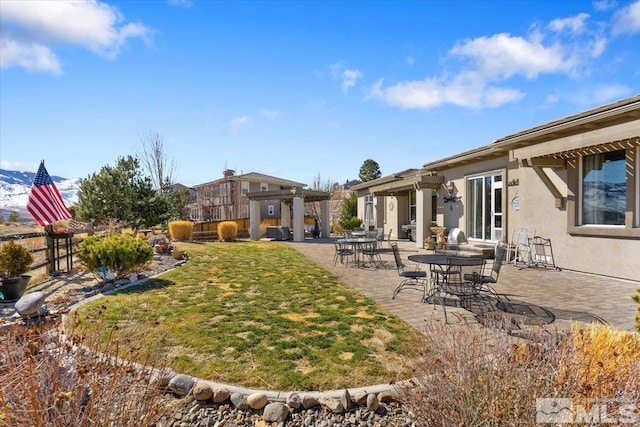 view of yard with a patio area, fence, and a pergola