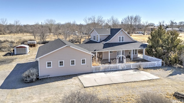 back of property with a patio area and fence