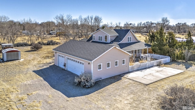 view of front of property with a garage, driveway, and roof with shingles