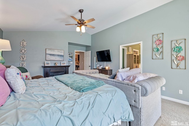 carpeted bedroom with lofted ceiling, ceiling fan, baseboards, and ensuite bathroom