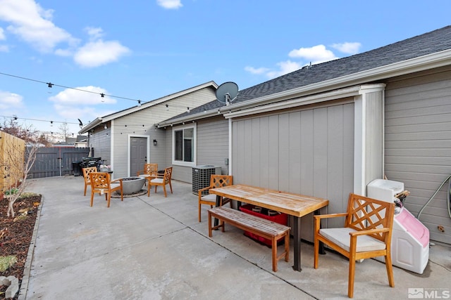 view of patio featuring central AC unit, an outdoor fire pit, and fence