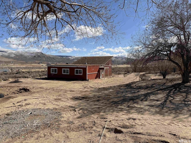 exterior space with an outbuilding and a mountain view