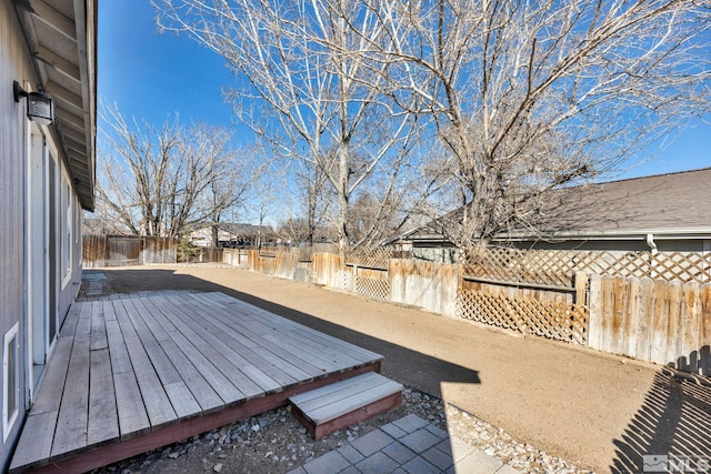 wooden terrace featuring a fenced backyard