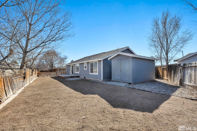 back of house with a fenced backyard