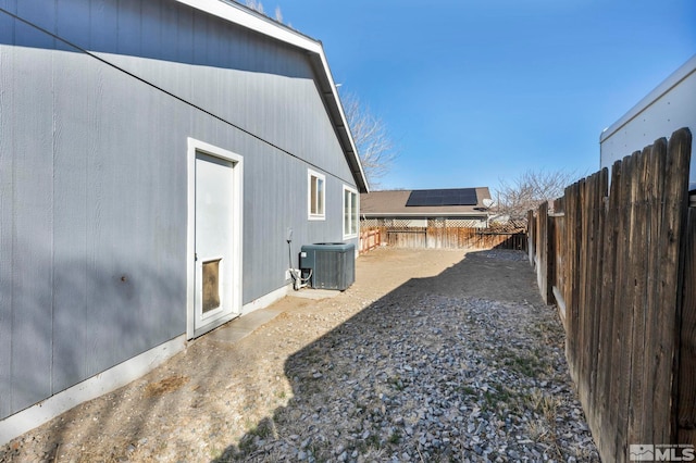 view of yard with central AC and a fenced backyard