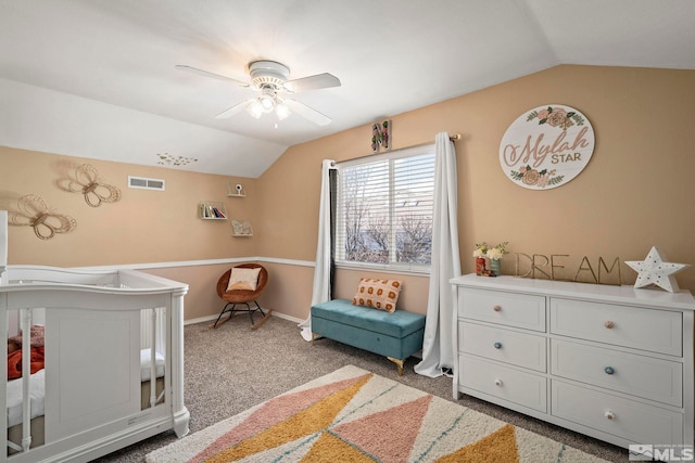 carpeted bedroom featuring visible vents, baseboards, a ceiling fan, and vaulted ceiling