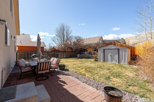 view of patio / terrace featuring an outdoor structure, a fenced backyard, and a storage shed