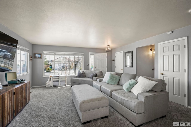 living room with carpet flooring, a textured ceiling, and baseboards