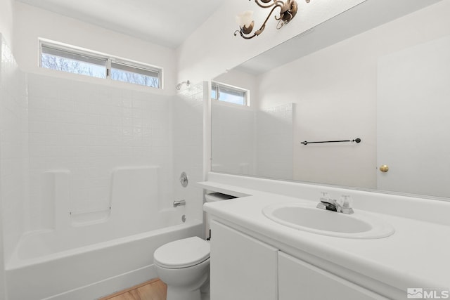 full bath with bathtub / shower combination, toilet, wood finished floors, and vanity