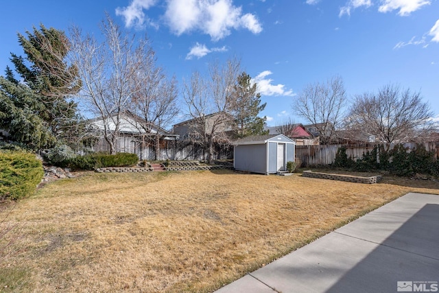 view of yard with an outdoor structure, a storage unit, and fence