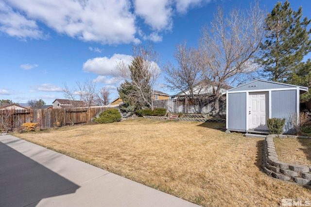 view of yard with an outdoor structure, fence private yard, and a shed