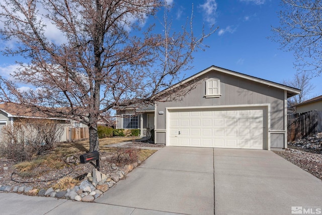 ranch-style home featuring concrete driveway, a garage, and fence