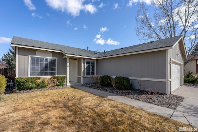 single story home featuring driveway, a front yard, and a garage