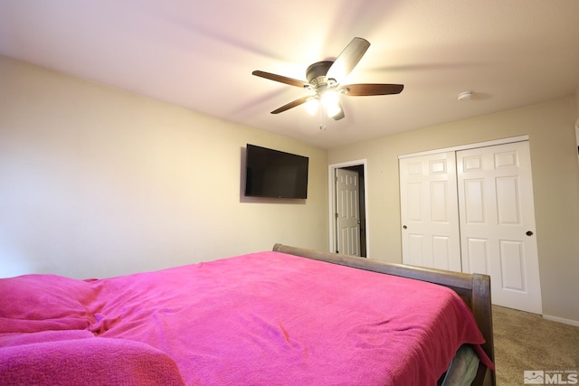 bedroom with a closet, a ceiling fan, and carpet flooring