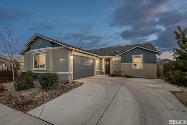 single story home with a garage, a shingled roof, concrete driveway, fence, and board and batten siding