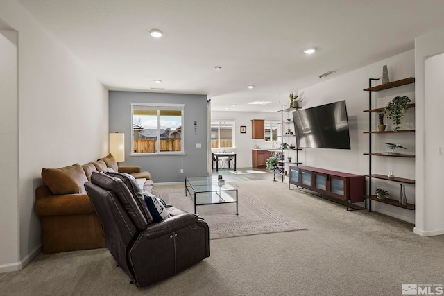 carpeted living area with recessed lighting, visible vents, and baseboards